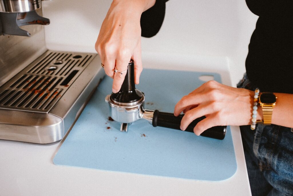 a woman is using a grinder on a blue mat